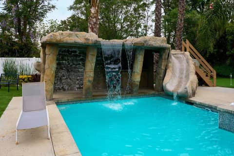 Resort Pool Home with Grotto, Waterslide and Cave Bar